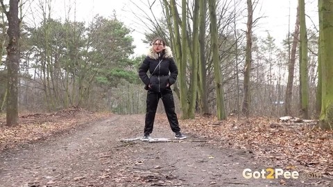 Solo girl Natasha Ink squats for a pee on a dirt road in glasses and a coat | Фото 13