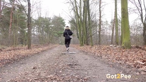 Solo girl Natasha Ink squats for a pee on a dirt road in glasses and a coat | Фото 15