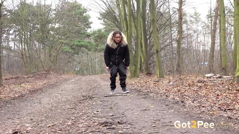 Solo girl Natasha Ink squats for a pee on a dirt road in glasses and a coat | Фото 2