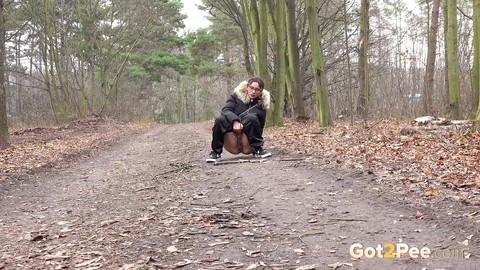 Solo girl Natasha Ink squats for a pee on a dirt road in glasses and a coat | Фото 3