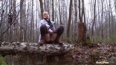 Clothed girl Anya pulls down tights on a log to pee into a stream in the woods | Фото 10