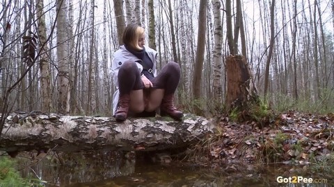 Clothed girl Anya pulls down tights on a log to pee into a stream in the woods | Фото 12