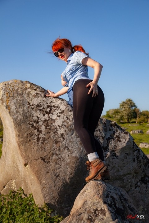 UK chick Red exposes her juggs on a rock before putting her hand down tights | Фото 8