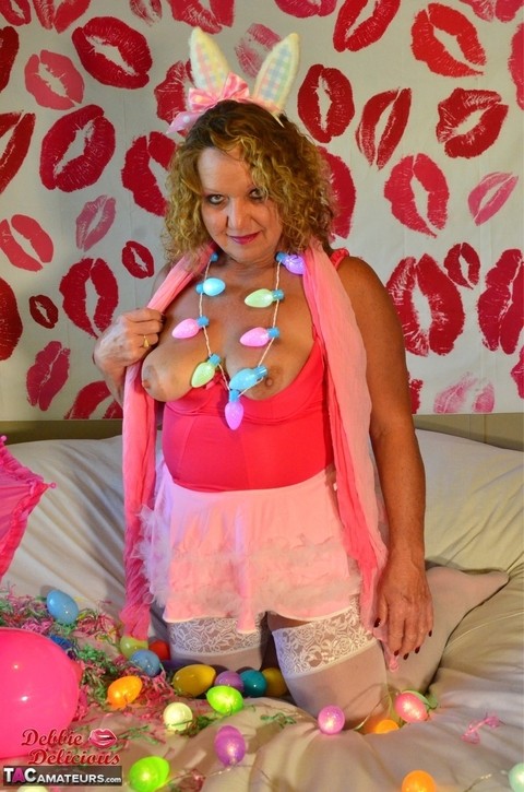 Mature amateur Debbie Delicious licks a nipple while donned in Easter attire | Фото 11