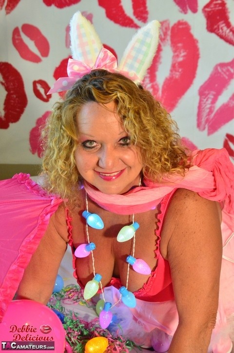 Mature amateur Debbie Delicious licks a nipple while donned in Easter attire | Фото 4