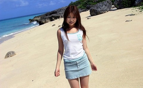 Adorable Japanese girl Miyu Sugiura frees sand clad ass while getting naked | Фото 1