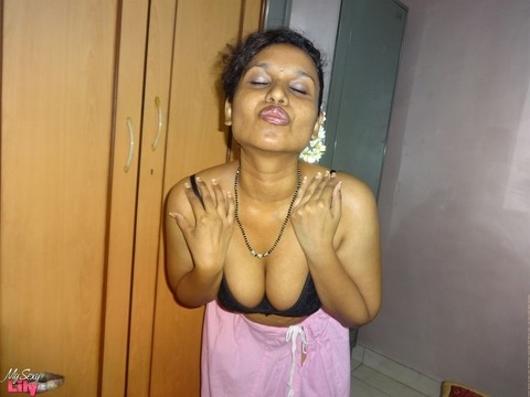 Clothed Indian woman strips to her black bra and underskirt