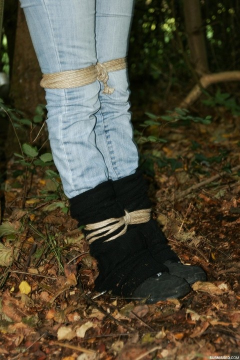 Sexy black haired Vixen gagged & roped up in jeans & boots & tied to a tree | Фото 12