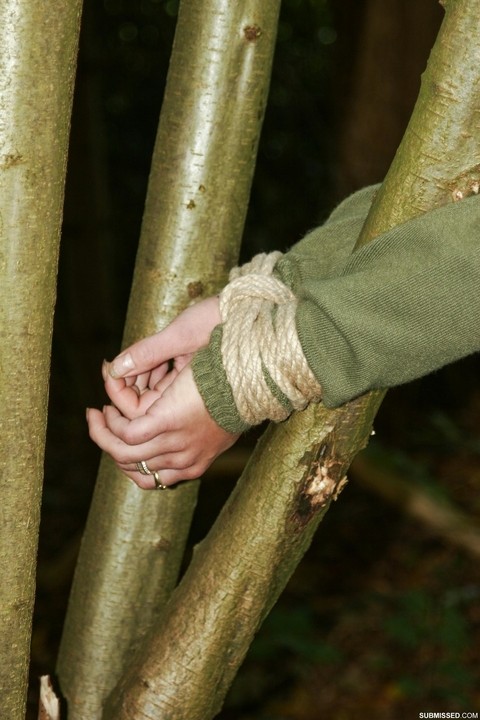 Sexy black haired Vixen gagged & roped up in jeans & boots & tied to a tree | Фото 17