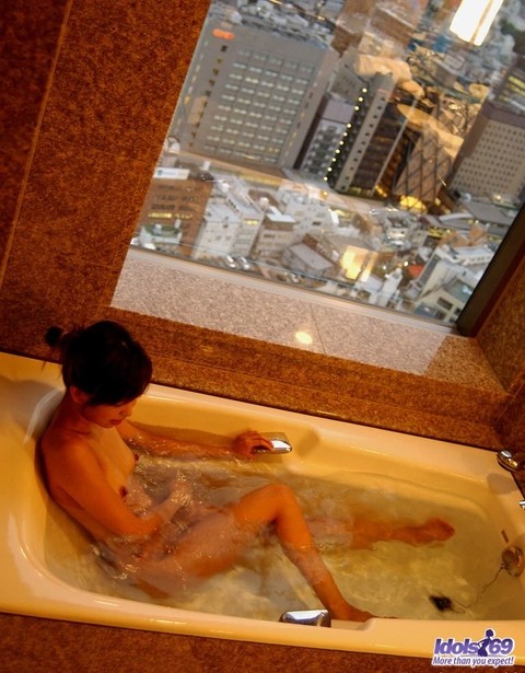 Young Japanese girl Sunao removes a skirt before taking a bath | Фото 16