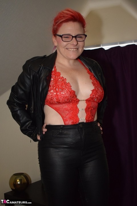 Thick redhead Mollie Foxxx frees her bald twat from leather pants and a thong