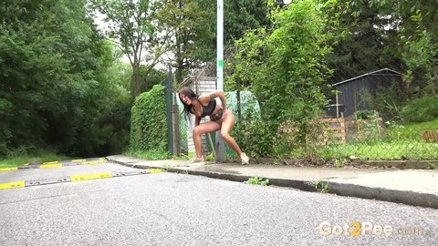 Solo girl Isabel Dark lets loose with a stream pf piss on a public sidewalk