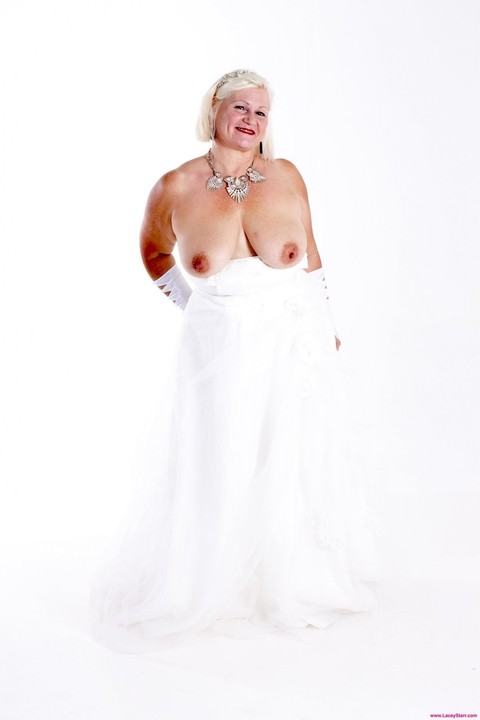 Mature bride Lacey Starr blowing off her new black hubby on their wedding day