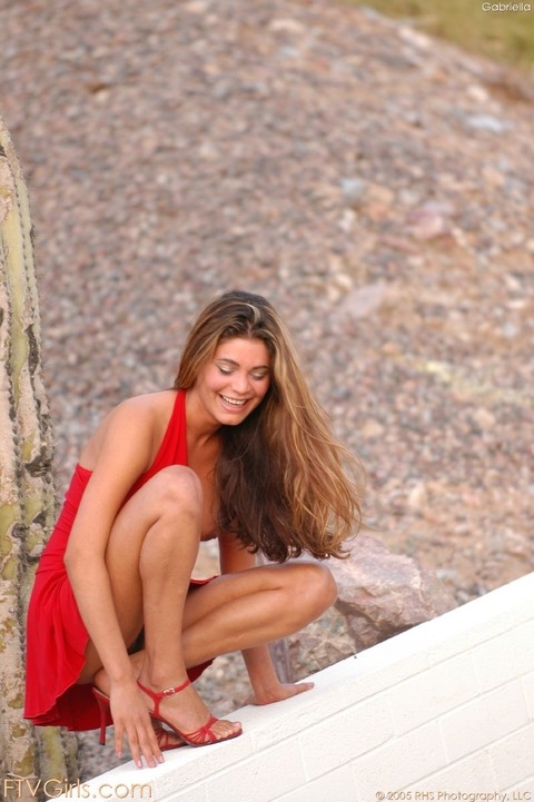 Sexy amateur babe Gabriella hikes her red dress and flaunts her trimmed muff | Фото 17