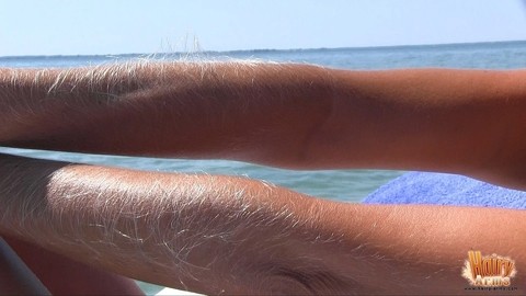 MILF Lori Anderson showing her hairy arms while relaxing nude at the beach | Фото 17