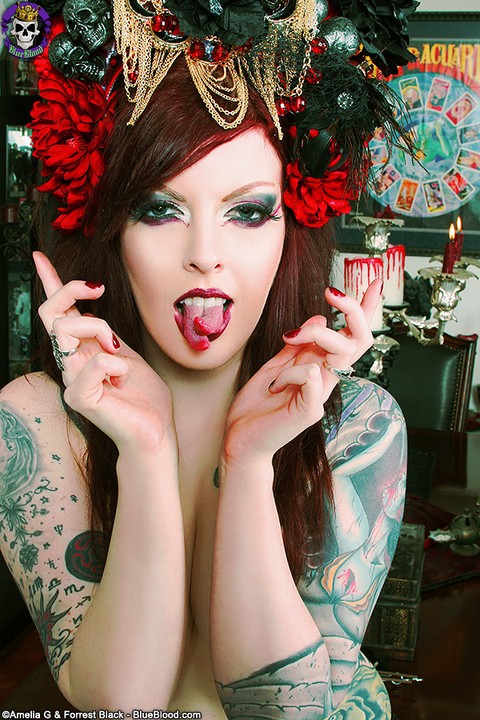 Inked redheaded Goth Penny Poison displays her split tongue during solo action | Фото 13