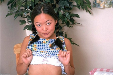 Asian first timer Amy undressing to model naked in pigtails on chair | Фото 2