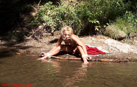 Blonde girl is bound hand and wrist after being ball gagged at river's edge | Фото 10