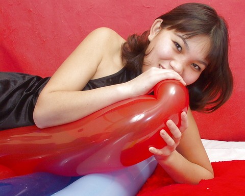 Naughty thai girl in sexy dress playing with a big red balloon | Фото 13