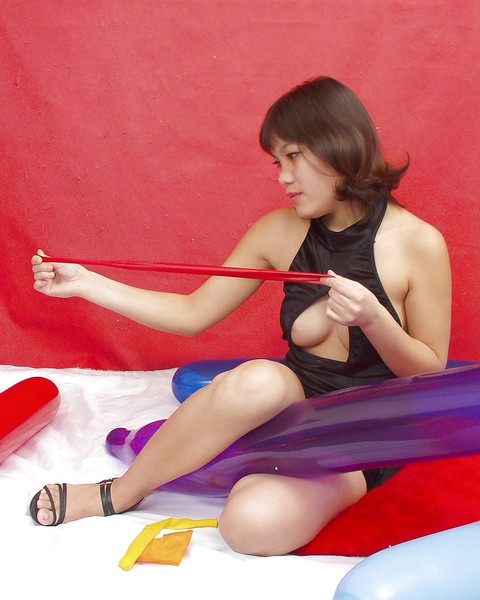 Naughty thai girl in sexy dress playing with a big red balloon | Фото 3