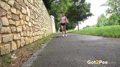 Short taken girl Mistica squats for a piss on a paved path in an urban setting | Фото 1