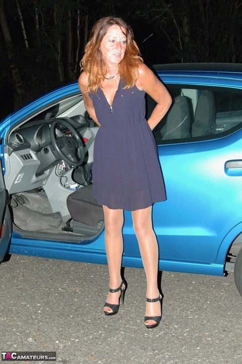 Mature woman Kyras Nylons exposes a breast in hose outside her car at night