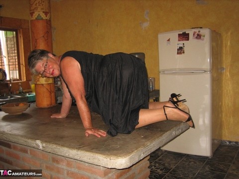 Fat oma Girdle Goddess strips to tan pantyhose on an island in the kitchen | Фото 5