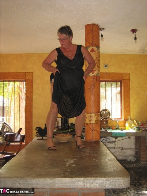 Fat oma Girdle Goddess strips to tan pantyhose on an island in the kitchen | Фото 7