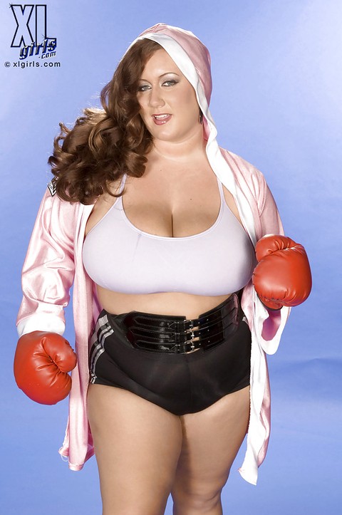 Chubby beauty in boxing gloves gets her huge knockers exposed and oiled up