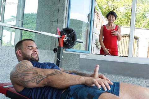 Lusty granny Petra T gets fucked by a muscular tattooed dude at the gym