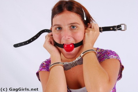 Clothed redhead fits herself with a ball gag while wearing handcuffs | Фото 3