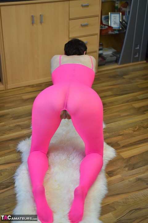 Mature amateur Hot MILF takes off a crotchless pink bodystocking atop a rug