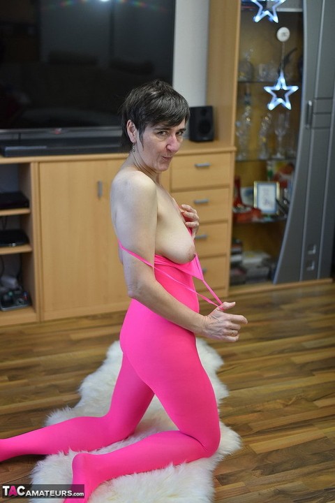 Mature amateur Hot MILF takes off a crotchless pink bodystocking atop a rug | Фото 15