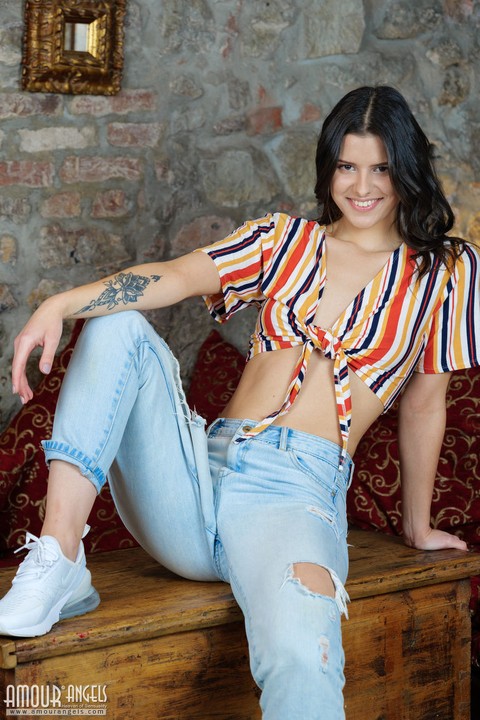 Young brunette Amelia Grace slowly undresses on top of a wooden trunk | Фото 3