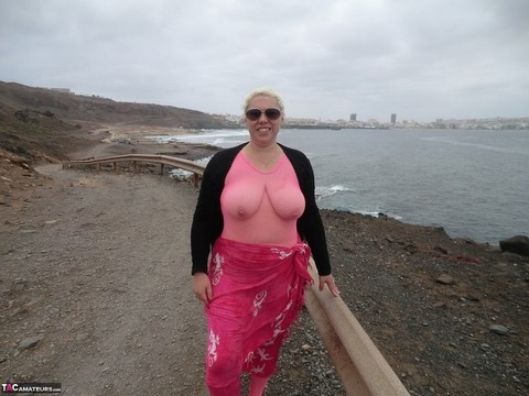 Aged lady Barby looses her big tits from a crotchless bodystocking by the sea