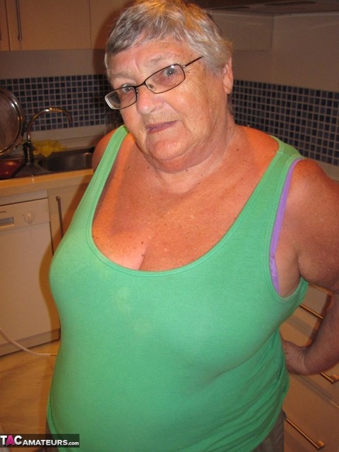 Overweight British oma Grandma Libby exposes her boobs while ironing