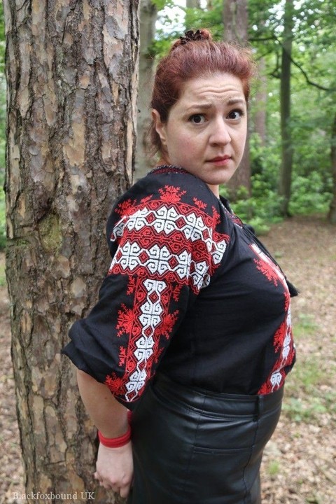 Thick redhead is cleave gagged and tied to a tree in a forest