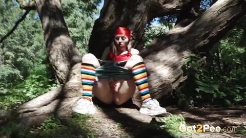 Young blonde Larisa takes a pee behind a tree in multi-coloured knee socks | Фото 5