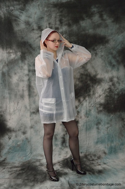 Redheaded chick in a raincoat and glasses gets tied up and gagged