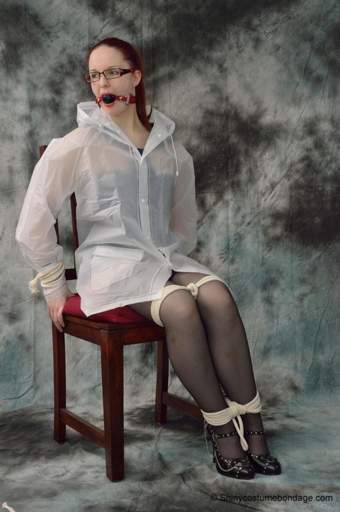 Redheaded chick in a raincoat and glasses gets tied up and gagged | Фото 3