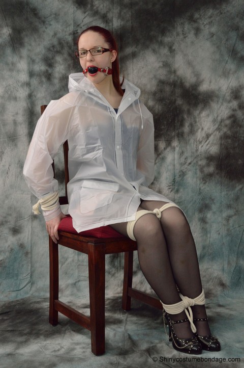 Redheaded chick in a raincoat and glasses gets tied up and gagged | Фото 6