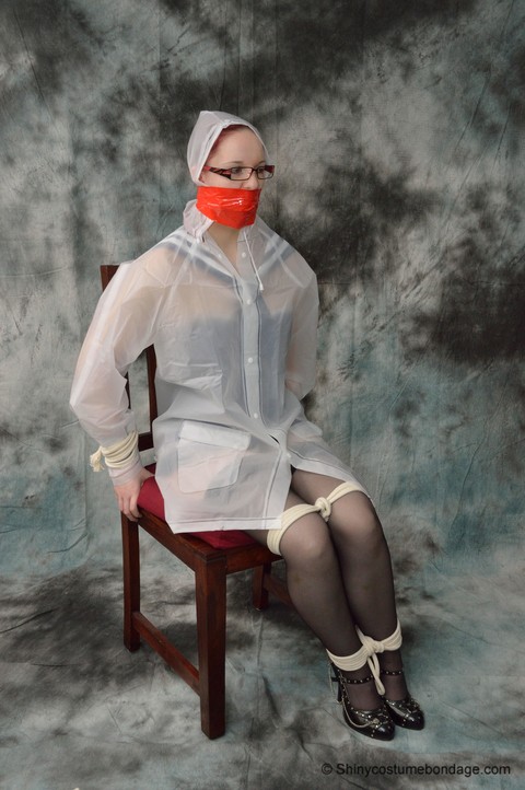 Redheaded chick in a raincoat and glasses gets tied up and gagged | Фото 8