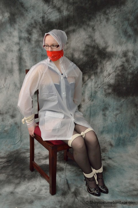 Redheaded chick in a raincoat and glasses gets tied up and gagged | Фото 9