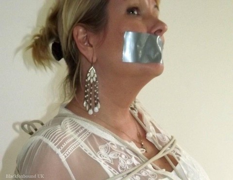 Blonde woman is silenced with duct tape while her tits are bound with rope | Фото 5