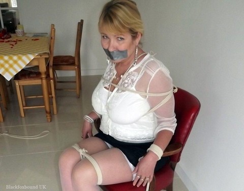 Blonde woman is silenced with duct tape while her tits are bound with rope | Фото 7