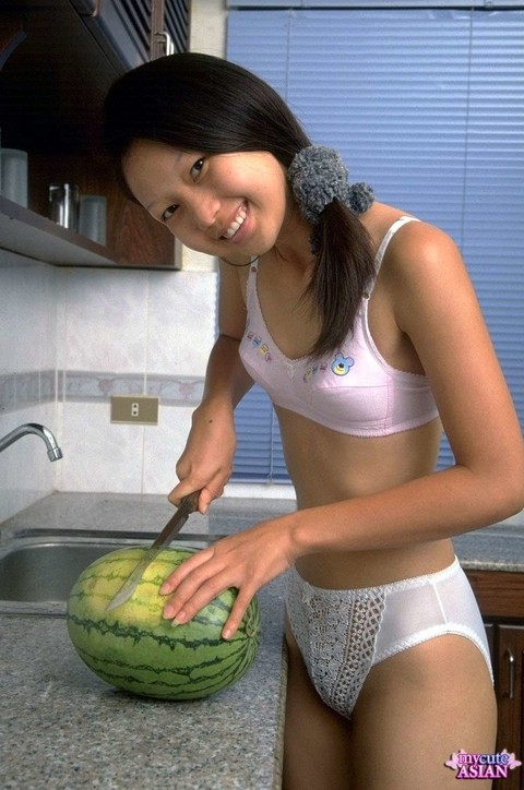 Petite Asian girl spreads her tight pussy after eating watermelon | Фото 1