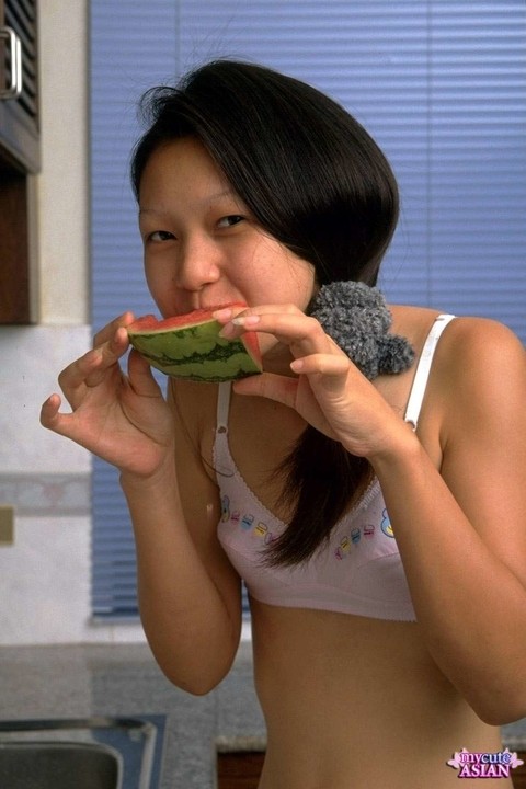 Petite Asian girl spreads her tight pussy after eating watermelon | Фото 3