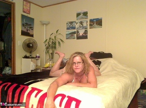 Busty Middle-aged amateur Misha MILF rides a dildo on her bed in glasses | Фото 1