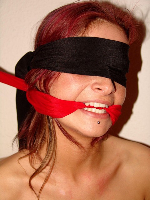 Restrained redhead struggles against her bindings while blindfolded and gagged | Фото 7