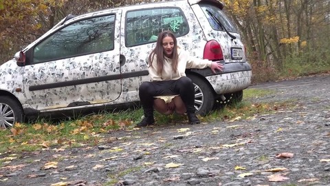 White girl Nicolette Noir takes a piss beside a parked car in a wooded setting | Фото 3